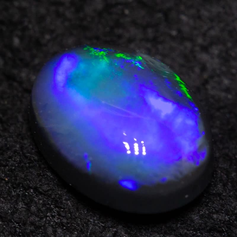 0.54 ct black opal 6.5x4.9x2.9mm