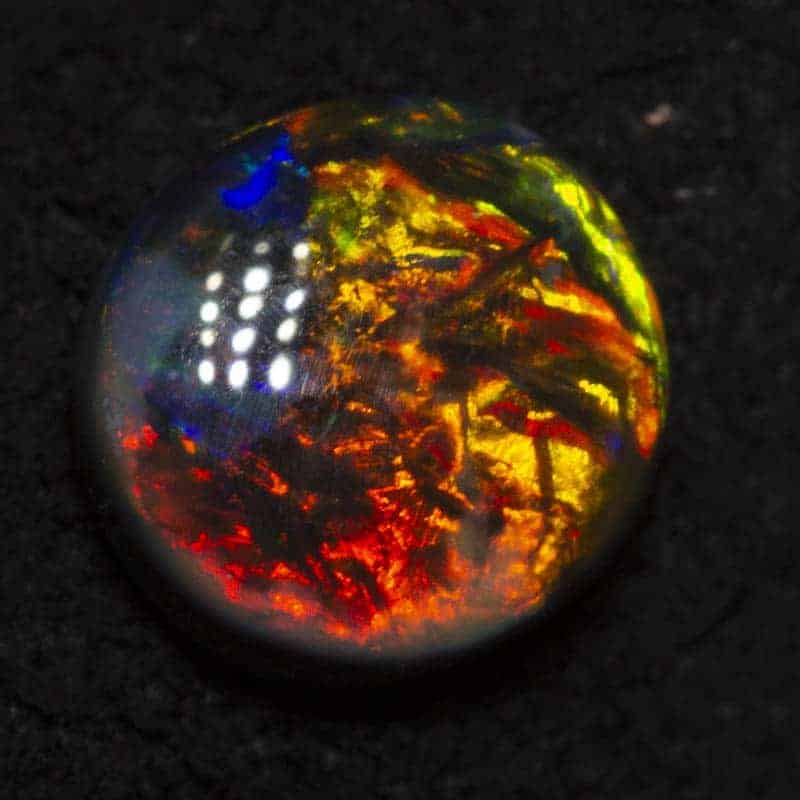 0.61 ct black opal 5.6mm round x 2.9mm
