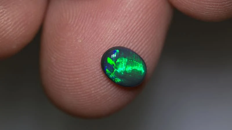 0.72 ct black opal 7x5.5x2mm
