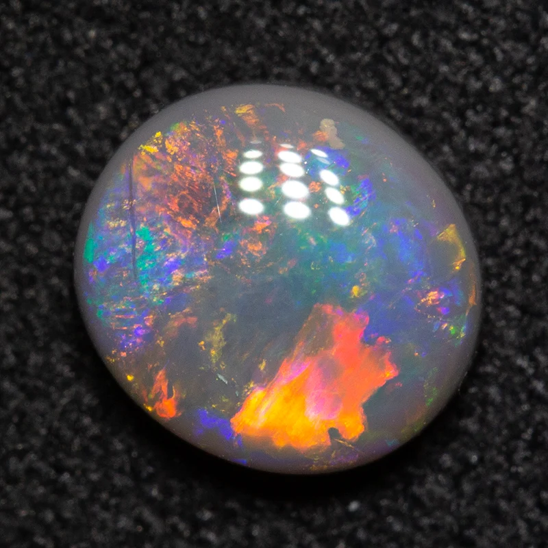 0.91 ct black opal 7x6.5x3mm