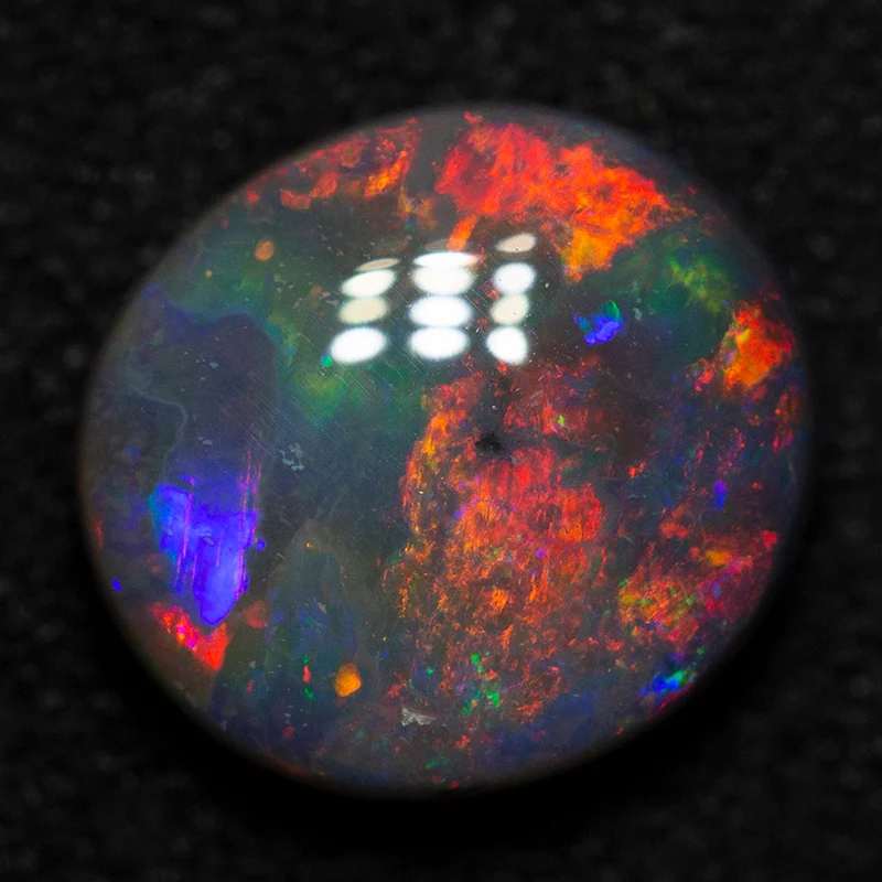 1.55 ct black opal 8.5x7.7x3.5mm
